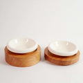 PawGlow elevated wood feeding bowls, set of two on a plain background