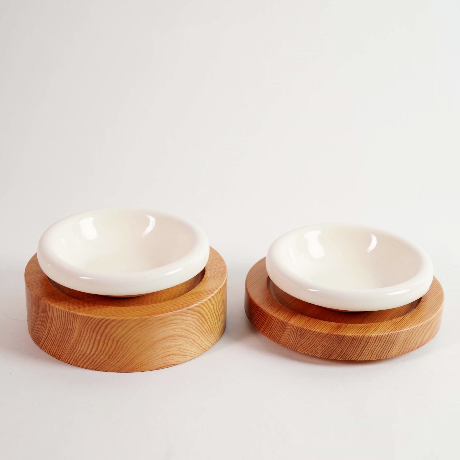 PawGlow elevated wood feeding bowls, set of two on a plain background